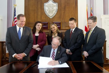 Alabama Gov. Robert Bentley ceremonially signs SB 67 into law at the state Capitol in Montgomery, Thursday, May 21, 2015. The historic criminal justice reform bill was sponsored by state Sen. Cam Ward, left, and state Rep. Mike Jones, second from right. Also pictured are Corrections Commissioner Jeff Dunn, right and state Rep. Vivian Figures, behind Gov. Bentley. The bill is designed to significantly reduce the state's prison population and bolster public safety through an overhaul of how people are supervised after being released from incarceration. (Governor's Office, Jamie Martin)
