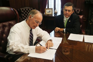 Alabama Governor Robert Bentley signs agreement in principle to settle its lawsuit with BP for damages caused by the 2010 Deepwater Horizon oil spill. Governor Bentley is joined by Alabama Department of Conservation and Natural Resources Commissioner Gunter Guy. Wednesday, July 1, 2015. (Governor's Office, Daniel Sparkman)