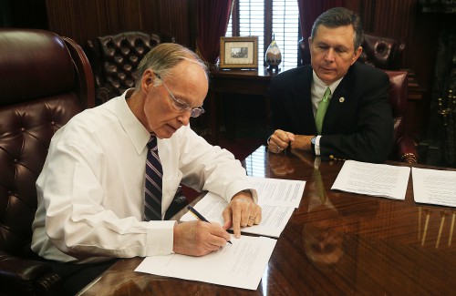 Alabama Governor Robert Bentley signs agreement in principle to settle its lawsuit with BP for damages caused by the 2010 Deepwater Horizon oil spill. Governor Bentley is joined by Alabama Department of Conservation and Natural Resources Commissioner Gunter Guy. Wednesday, July 1, 2015. (Governor's Office, Daniel Sparkman)