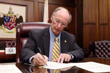 Alabama Gov. Robert Bentley signs a Proclamation officially calling the state Legislature into a second special session at the Capitol in Montgomery, Thursday, Sept. 3, 2015. Lawmakers must address a $200 million budget shortfall that drastically cuts state agencies. (Governor's Office, Jamie Martin)