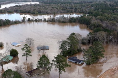 Flooding outside of an improved levee near the downtown area of the flood-prone town of  Elba, Alabama, shown Saturday, Dec. 26, 2015, has been widespread, but the new levee has kept water out of the of downtown. The Pea River is expected to crest at midnight tonight, near 43 feet. The  town was underwater in 1929, which led to the constructions of levees for protection. The city flooded again in 1990 when rising waters overwhelmed levees and again in 1998 when a levee failed under pressure from flood waters. (Governor's Office, Jamie Martin)