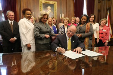 Alabama Governor Robert Bentley signs an Executive Order establishing the Health Literacy Partnership of Alabama in his office at the State Capitol in Montgomery on Wednesday, April 20, 2016. Joining Governor Bentley are members of the group which will recommend ways to improve the health literacy of Alabamians. (Governor's Office, Daniel Sparkman)