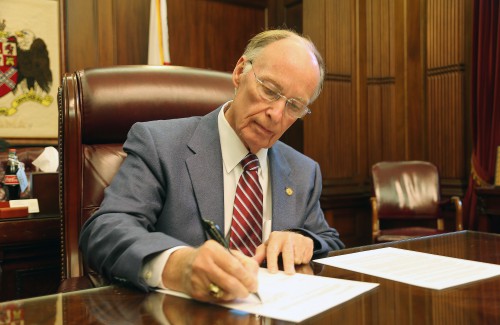 Alabama Governor Robert Bentley signs Executive Order 20 authorizing Alabama county children’s policy councils to work with local Child Advocacy Centers to develop child sexual abuse prevention plans in his office at the State Capitol on Thursday, April 28, 2016. (Governor's Office, Daniel Sparkman)