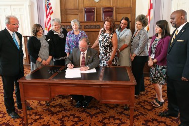 Alabama Governor Robert Bentley signs HB238, Erin's Law, sponsored by state Representative Terri Collins during a ceremonial bill signing in the Old House Chamber at the State Capitol in Montgomery on Tuesday, May 17, 2016. Joining Governor Bentley and Rep. Collins for the signing were members of the Governor’s Task Force on Prevention of Sexual Abuse of Children which suggested the legislation. (Governor's Office, Daniel Sparkman)
