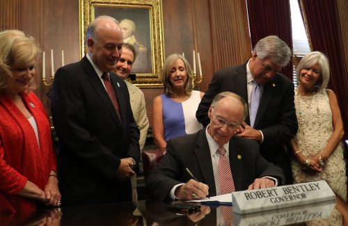 Alabama Gov. Robert Bentley ceremonially signs SB 11, the Jason Flatt Act, sponsored by Sen. Gerald Allen and Rep. Steve Clouse, in his state Capitol office in Montgomery, Tuesday, June 28, 2016. The bill provides for suicide prevention educational training programs for K-12 students. Pictured from left, Michelle Ray, Clark Flatt, Rep. Steve Clouse, Robin Sparks, Sen. Gerald Allen (Governor's Office, Jamie Martin)