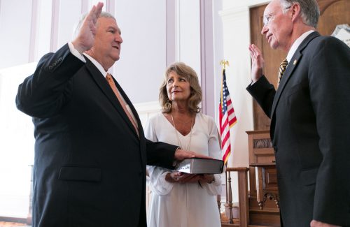 Alabama Gov. Robert Bentley, right, delivers the oath of office to Mike Hill, superintendent of the Alabama Banking Department in the Old House Chamber at the state Capitol in Montgomery, Tuesday, July 5, 2016, in Montgomery. Superintendent Hill's wife Carol holds the Bible. (Governor's Office, Sydney A. Foster)