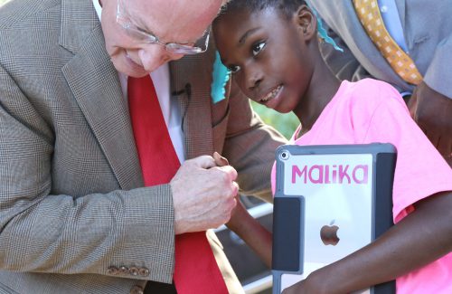 Alabama Governor Robert Bentley embraces young Malika Shoulders, a non-verbal student attending J.E. Hobbs Elementary School in Camden, Ala. Malika will be able to communicate better with her new iPad, one of hundreds donated as part of a $900,000 Apple grant made available through the White House ConnectED initiative to J.E. Hobbs Elementary School In Camden, Ala., which Gov. Bentley announced today Tuesday, Oct. 18, 2016 at the school.  As part of the grant, every student will receive an iPad, each teacher and administrator will receive a MacBook and iPad Mini along with an Apple TV for every classroom. Teachers will receive training and have been assigned a team of Apple specialists to provide ongoing professional development and support to incorporate the technology into their curriculum. (Governor's Office, Jamie Martin)